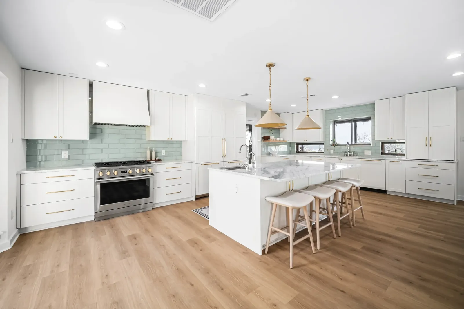 kitchen remodel with white cabinets and green brick backsplash