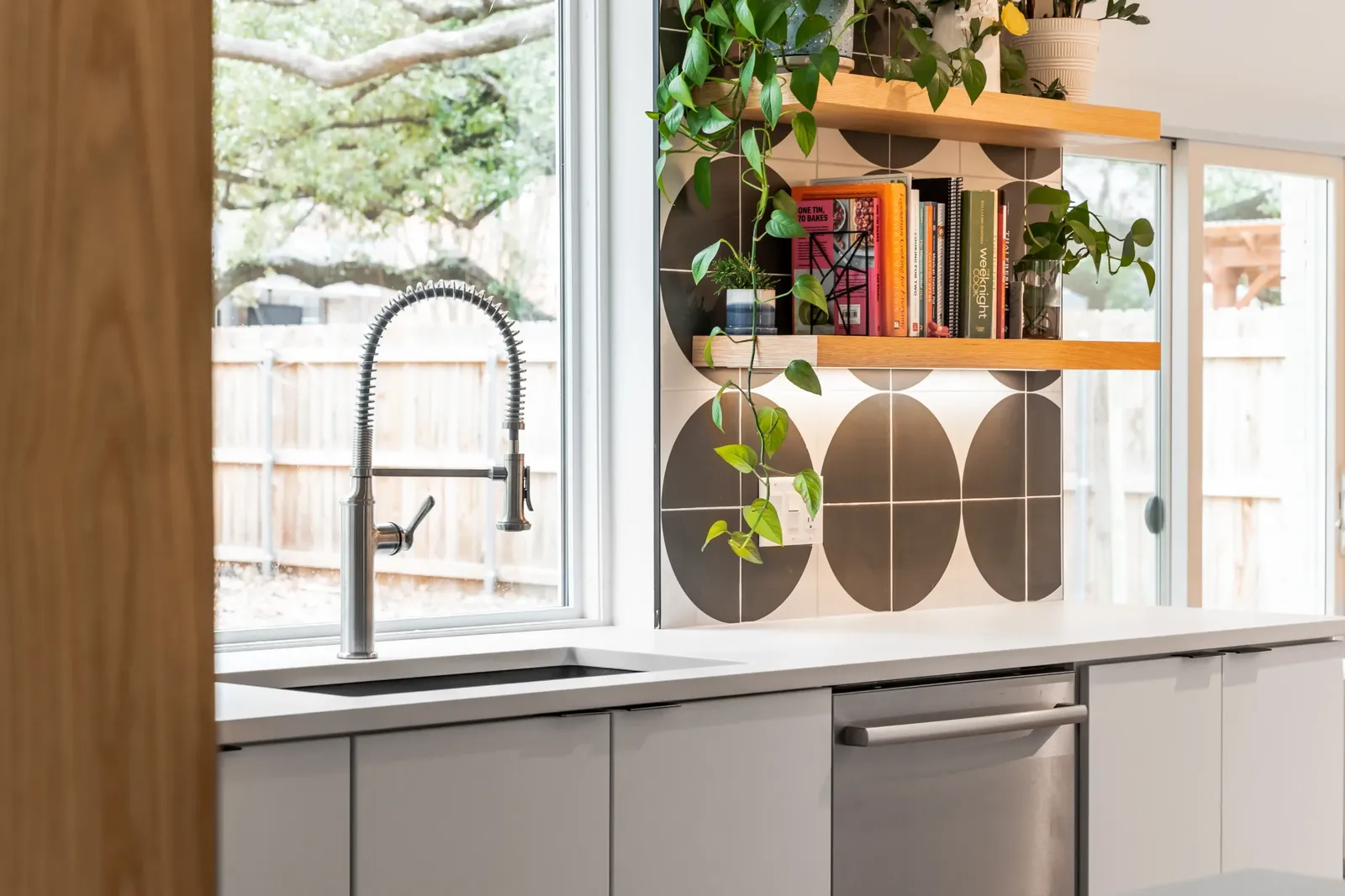 white kitchen cabinets with big polka dot backsplash