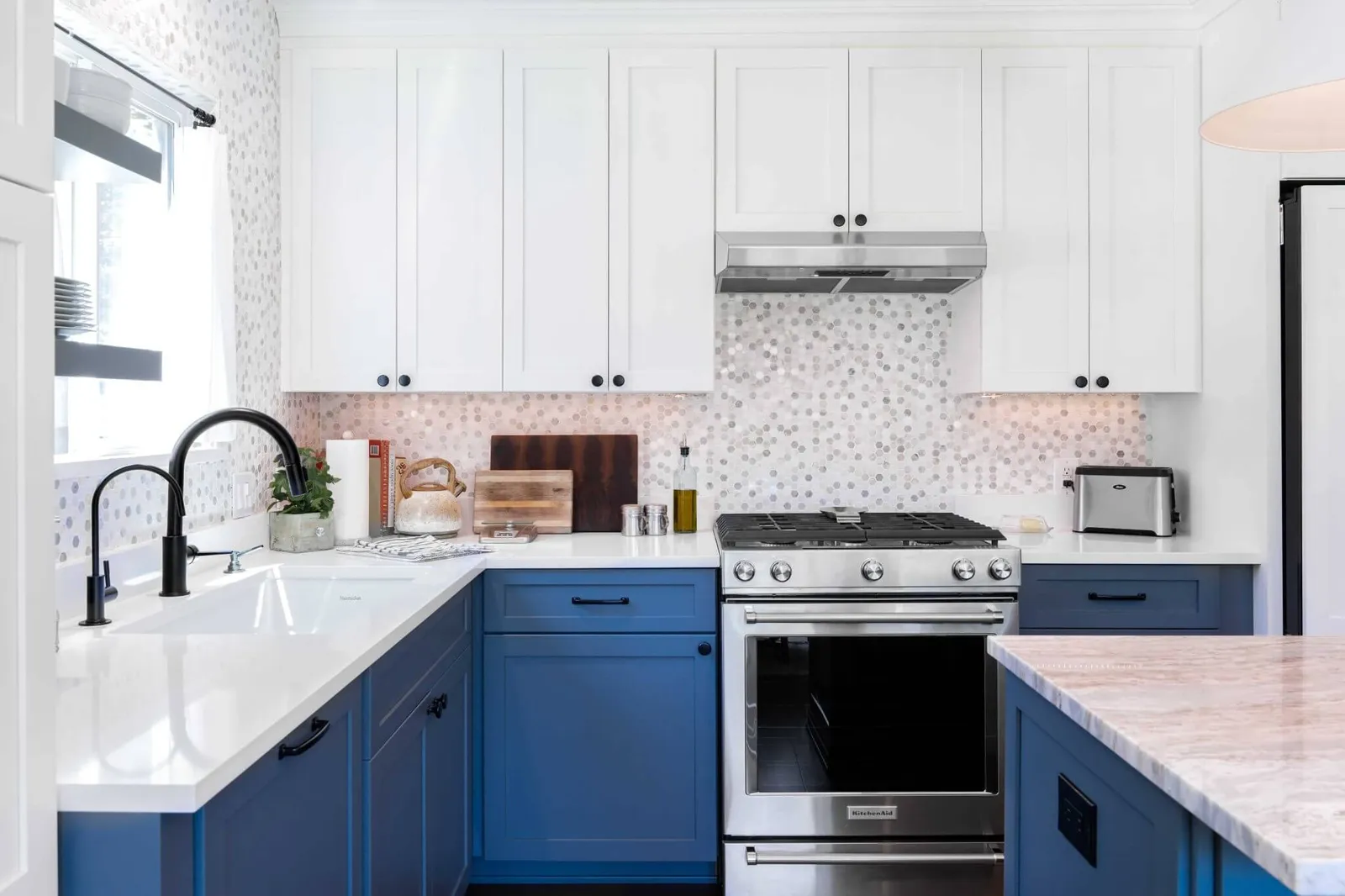 modern kitchen with blue cabinets, white countertops, and stainless steel appliances Cabinet IQ
