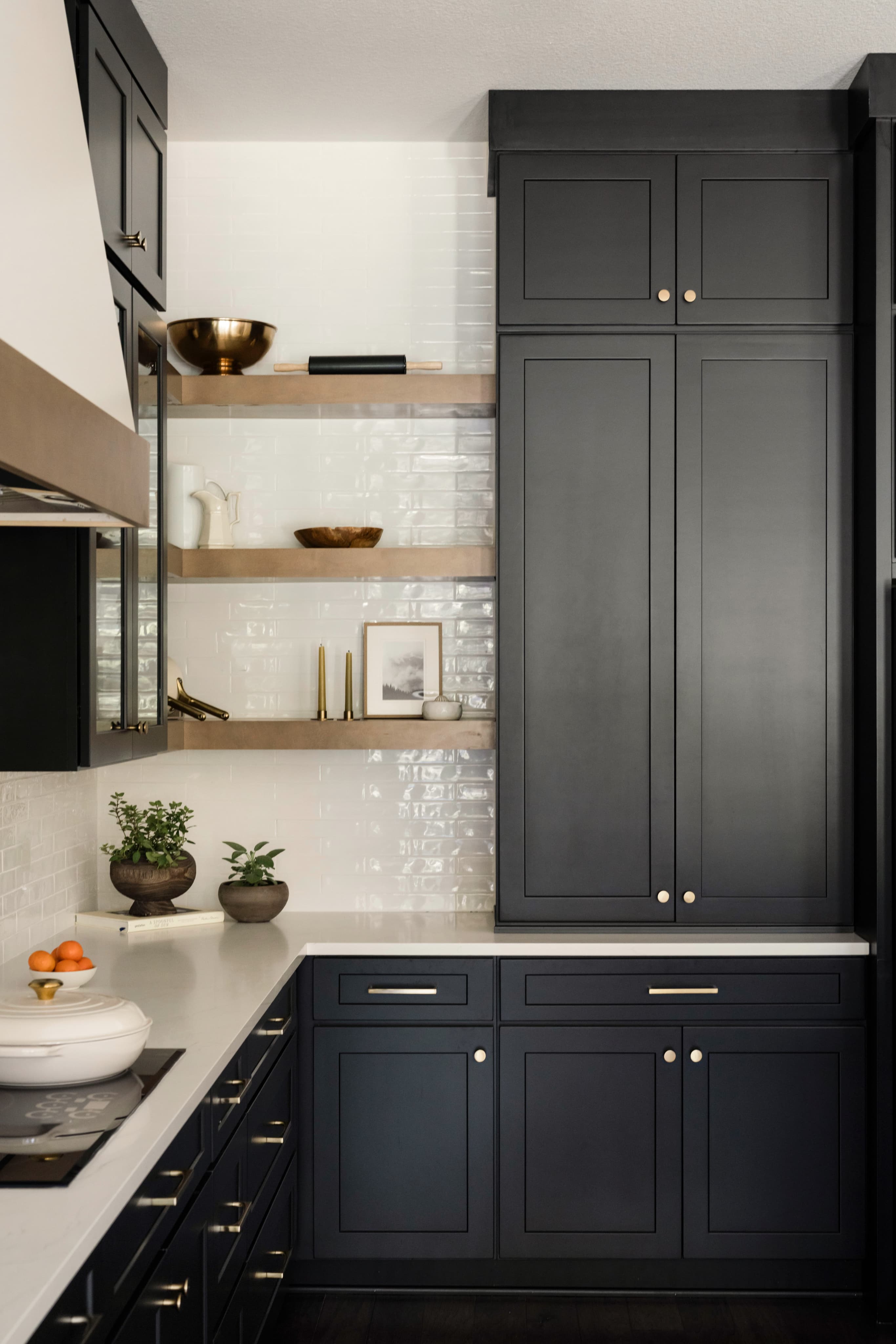 Stock cabinets — navy painted shaker doors with brass hardware