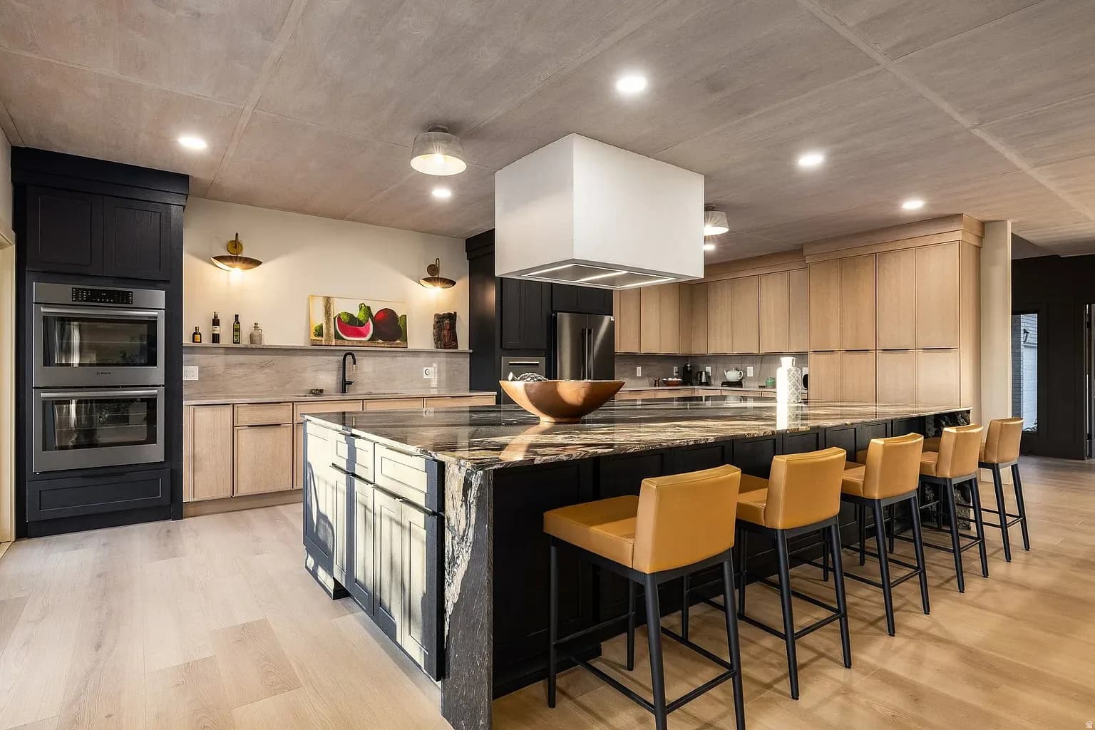 Grandridge kitchen with light oak cabinetry and a dark stone waterfall island