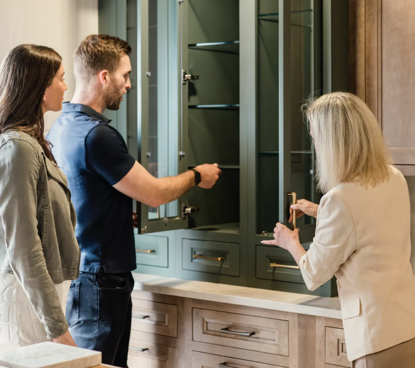 Cabinet IQ designer reviewing cabinetry with homeowners in the showroom