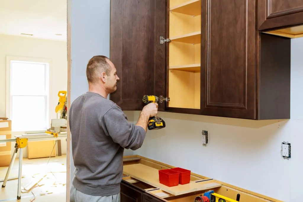 Installation of furniture hinges on the cabinet door kitchen