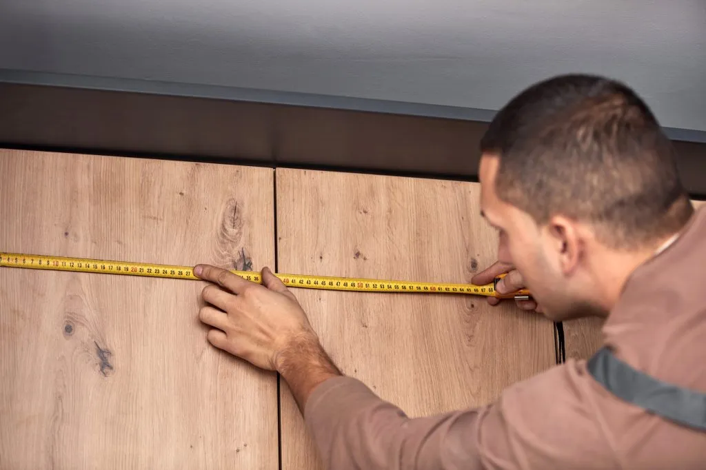 Handyman making kitchen wall cabinets