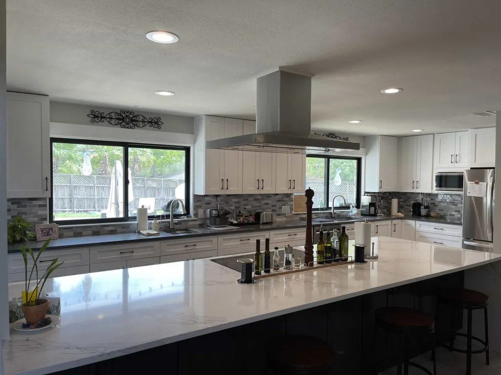 well-lit kitchen with stainless steel appliances, cabinet iq