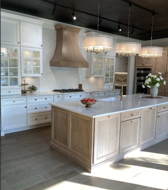 Cabinet IQ of Greensboro showroom display with painted perimeter cabinets, a white oak island and a marble-look slab